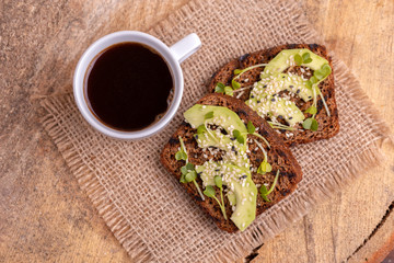 Healthy rye toasts with avocado and radish sprouts