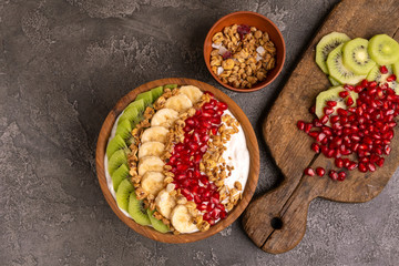 Vanilla acai bowl with kiwi, banana, pomegranate and granola