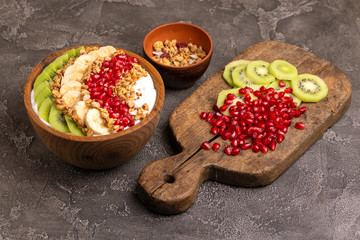 Vanilla acai bowl with kiwi, banana, pomegranate and granola
