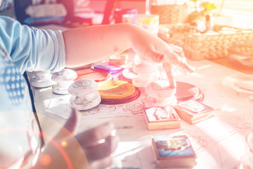 boy is having fun while playing with stamps and tempera paints on wooden work desk producting multicolor creations