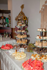 Different fruit desserts with fruits in glasses on the table. Restaurant presentation, food, party concept