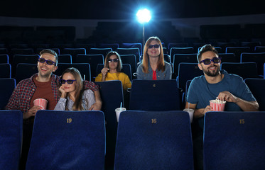 Young people watching movie in cinema theatre