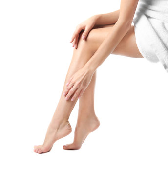 Woman with beautiful legs on white background, closeup. Spa treatment