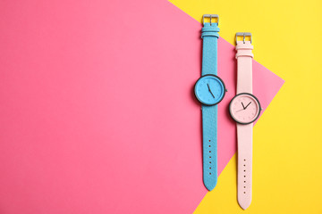 Flat lay composition with stylish wrist watches and space for text on color background. Fashion accessory