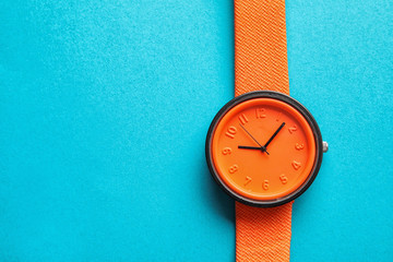 Stylish bright wrist watch on color background, top view with space for text. Fashion accessory - obrazy, fototapety, plakaty