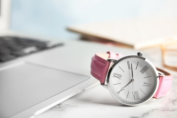 Fototapeta na wymiar Stylish wrist watch on office table, space for text. Fashion accessory
