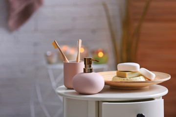 Aromatic soap and shampoo on table against blurred background. Space for text