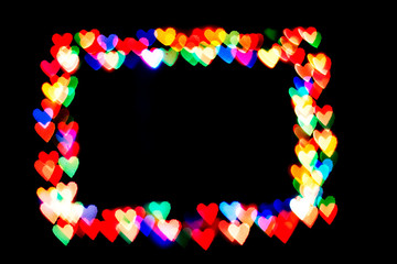 bokeh hearts isolated on a black background hearts of different colors form the frame.