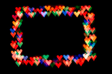 bokeh hearts isolated on a black background hearts of different colors form the frame.