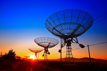 The silhouette of a radio telescope observatory