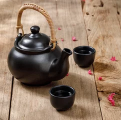 Foto op Aluminium Cup of hot tea with steaming jugs on the wooden table background with copyspace for your text, Chinese style © DN6