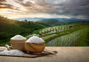 Jasmine rice and steamed rice in wooden bowl with the chopsticks on the wooden table with the...
