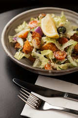 Tasty crumbed chicken salad served with tomato lettuce & cucumber ready for a healthy appetite. 
