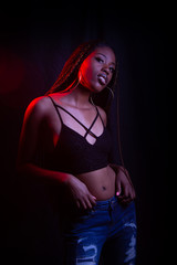 Black woman in studio with colored lights