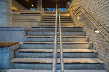 grain concrete staircase at ground floor with handrails