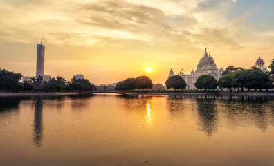 Fototapeta premium Victoria Memorial colonial architecture structure with lake at sunrise at Kolkata India.