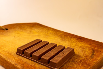 Chocolate bars on a rustic wooden board.