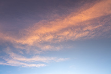 Sunset or sunrise sky with clouds and sunlight.