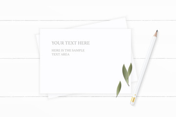 Flat lay top view elegant white composition paper nature leaf and pencil on wooden background