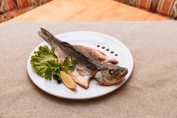 fried fish with fresh herbs and lemon