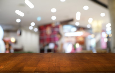 Empty dark wooden table in front of abstract blurred bokeh background of restaurant . can be used for display or montage your products.Mock up for space.