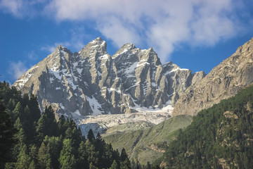 Fototapeta na wymiar A snow-capped mountain peak. A mountain with a glacier in the Himalayas of Kashmir