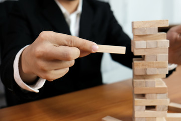 Planning risk and strategy in businessman gambling placing wooden block.Business concept for growth...