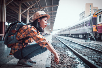 Asia young women tourists Being stressed and frustrated by a missing train travel. at Hua Lamphong Station Bangkok Thailand.