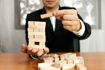 Planning risk and strategy in businessman gambling placing wooden block.Business concept for growth...