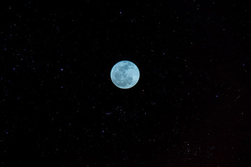 The red full moon in the twilight hour.