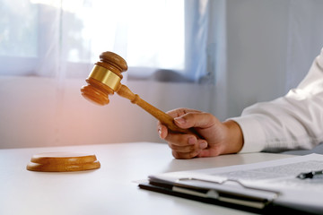 Legal counsel presents to the client a signed contract with gavel and legal law. justice and lawyer...