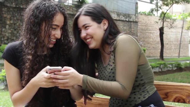 Girls look at cellphone in slow motion