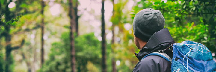 Travel hiking man hiker on trek hike with bag, hat, hiking poles. Active lifestyle people outdoor...