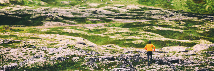 Trail run athlete running on winter mountain nature background panoramic banner. Endurance sport hiker on trek hike. Landscape crop header.