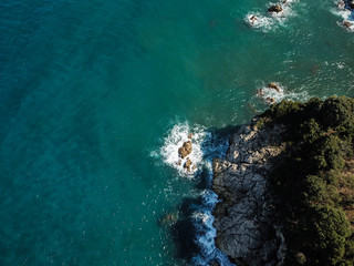 Drone top view of a sea cliff and a beach