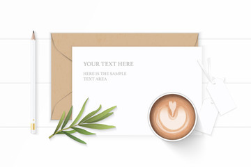 Flat lay top view elegant white composition letter kraft paper envelope tarragon leaf tags and pencil coffee on wooden background