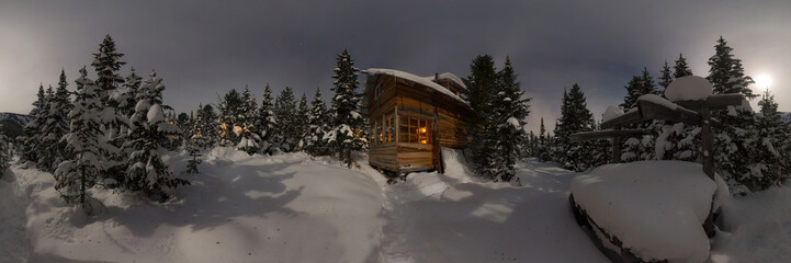 Panorama house chalet during a snowfall in the trees winter forest at night in the moonlight. Cilindrical 360 panorama