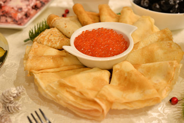 traditional thin Russian pancakes with red caviar