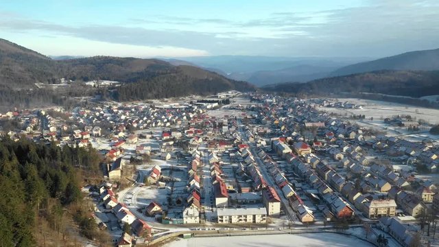 Panoramic view of Croatian town Delnice, Gorski Kotar in winter, slow drone flight over the town center 
