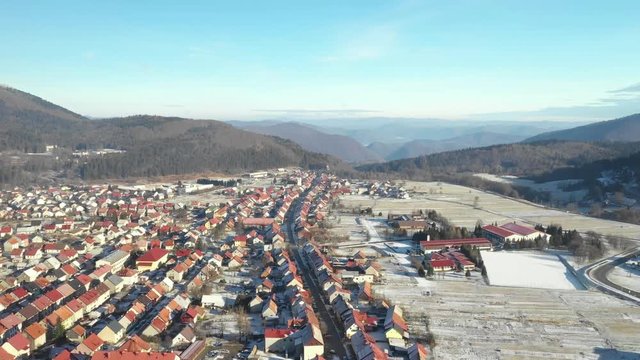 Panoramic view of Croatian town Delnice, Gorski Kotar in winter, slow drone flight over the town center 