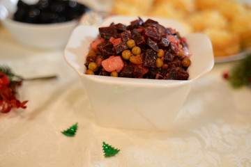 Traditional Russian beetroot vegetable salad Vinaigrette. Salad with beets, potatoes, carrots, pickles and peas 