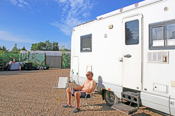 Man relaxing outside his camper van