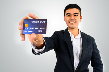 MEN BUSINESS WITH MOBILE PHONE OR CREDIT CARD IN WHITE BLACKGROUND