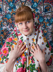 Portrait of a young woman in a traditional Russian dress scarf..