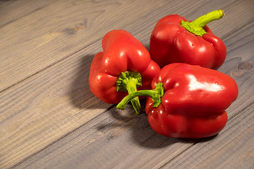 Three sweet red peppers on the table