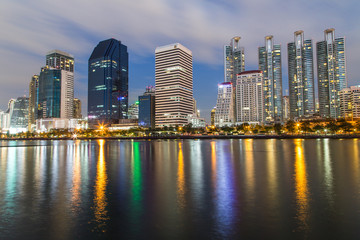 Bangkok twilight, Business building with light and reflection, view from Benjakitti park in Bangkok, Thailand