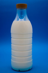 A bottle of milk on a blue background