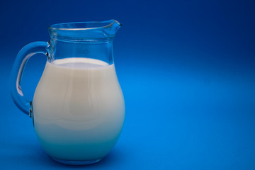 A jug of milk on a blue background