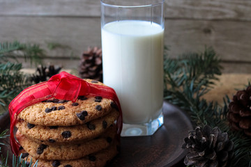 A glass of milk and cookies for Santa. Christmas Eve Concept.