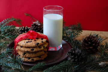 A glass of milk and cookies for Santa. Christmas Eve Concept.